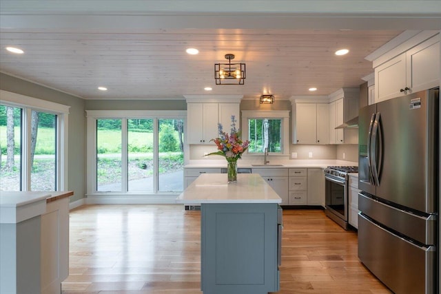 862 W Neck Rd, Nobleboro, ME 04555 - kitchen featuring stainless steel appliances, light countertops, a kitchen island, white cabinetry, and light wood finished floors