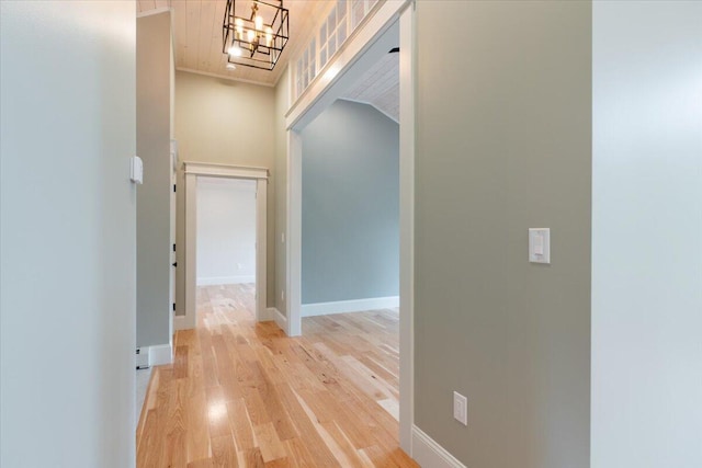 862 W Neck Rd, Nobleboro, ME 04555 - hallway with light wood-style flooring and a chandelier