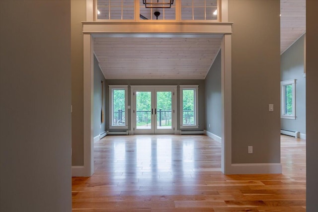 862 W Neck Rd, Nobleboro, ME 04555 - entrance foyer with a baseboard radiator, vaulted ceiling, plenty of natural light, wood finished floors, and french doors