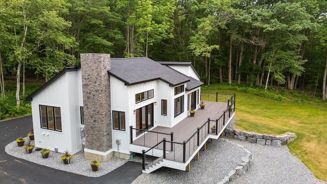 862 W Neck Rd, Nobleboro, ME 04555 - view of home's exterior with a chimney, roof with shingles, a yard, board and batten siding, and a wooded view