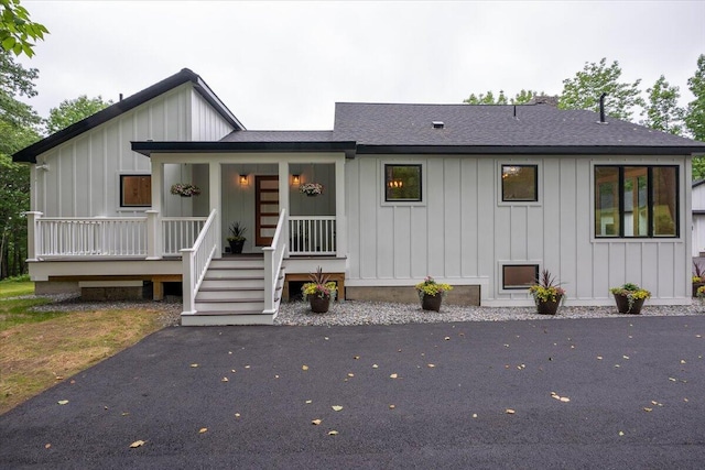 862 W Neck Rd, Nobleboro, ME 04555 - view of front facade with board and batten siding, roof with shingles, and a porch