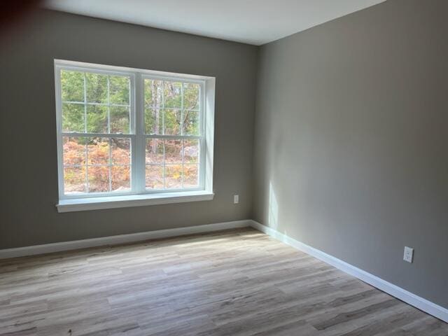 unfurnished room with light hardwood / wood-style flooring