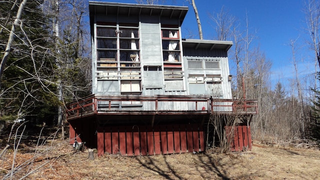 rear view of property featuring a wooden deck