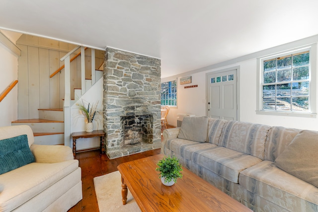 living room with a fireplace and dark wood-type flooring