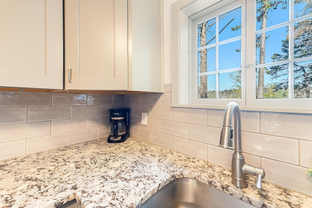 details featuring sink and backsplash