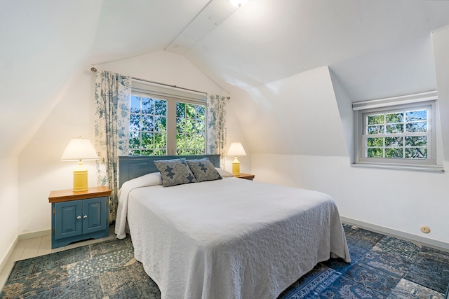 tiled bedroom with lofted ceiling