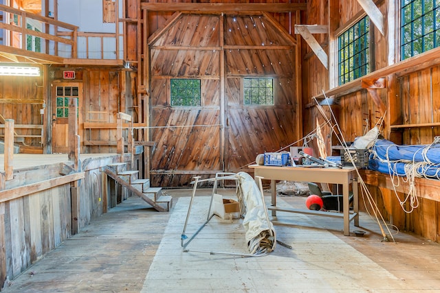 miscellaneous room with light hardwood / wood-style floors and a high ceiling