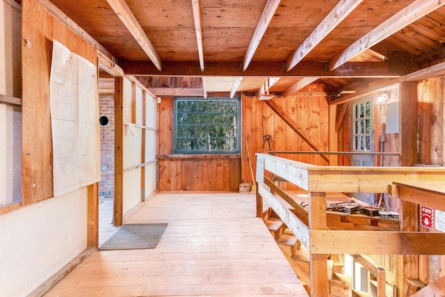 interior space with wooden ceiling, light wood-type flooring, and wooden walls