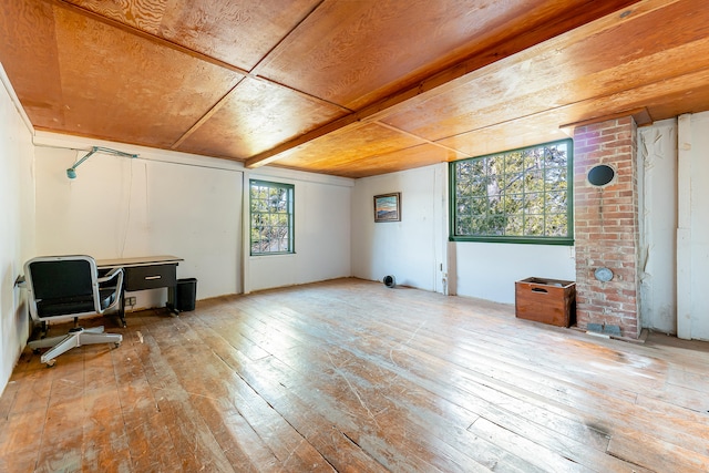 living room featuring light wood-type flooring and brick wall