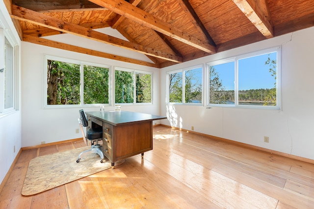 office space featuring a wealth of natural light, lofted ceiling with beams, and light wood-type flooring