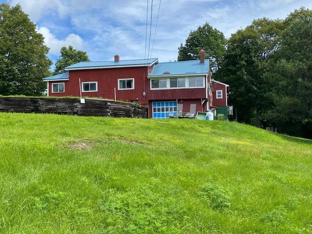 rear view of house featuring a yard