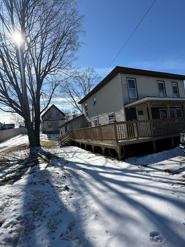 snow covered property featuring a deck