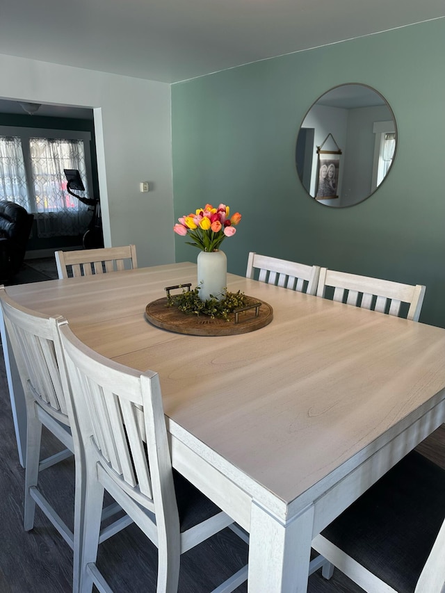 dining area with dark hardwood / wood-style flooring