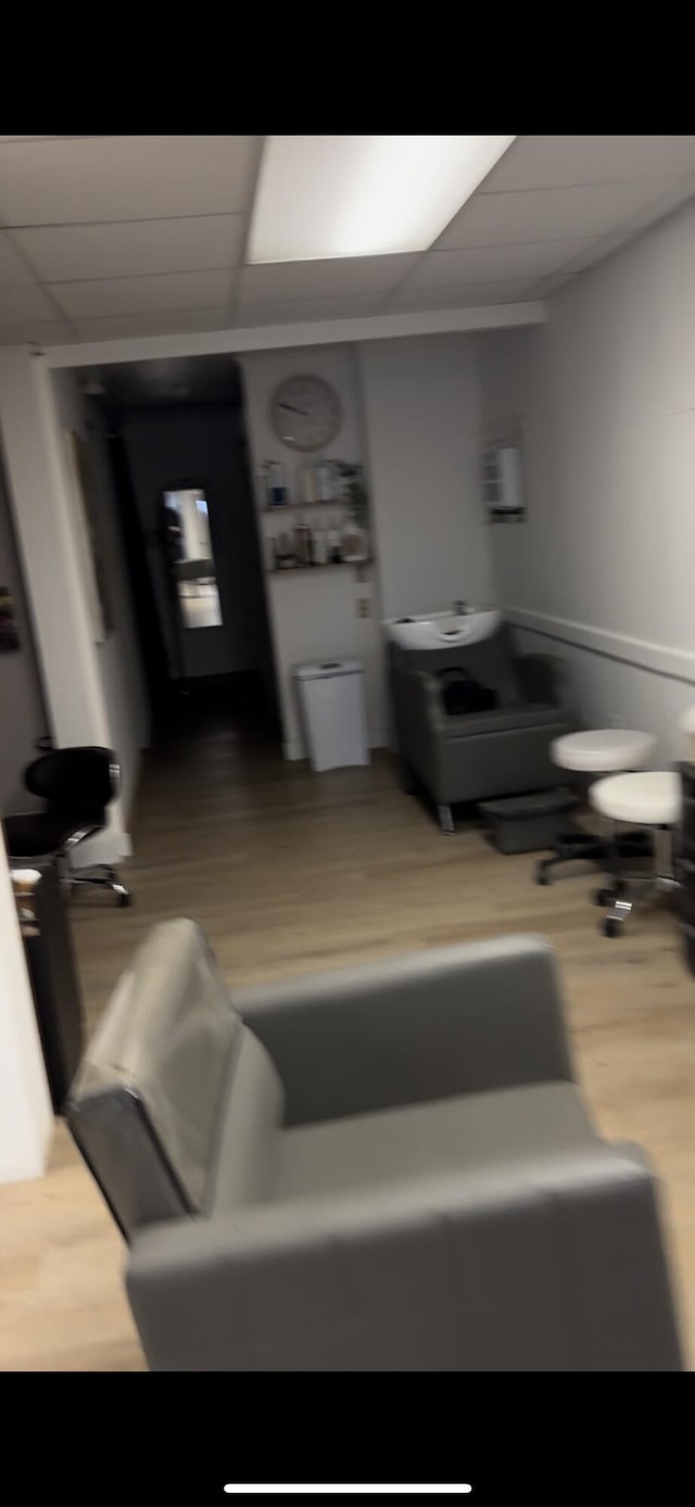 bathroom with a drop ceiling and wood-type flooring