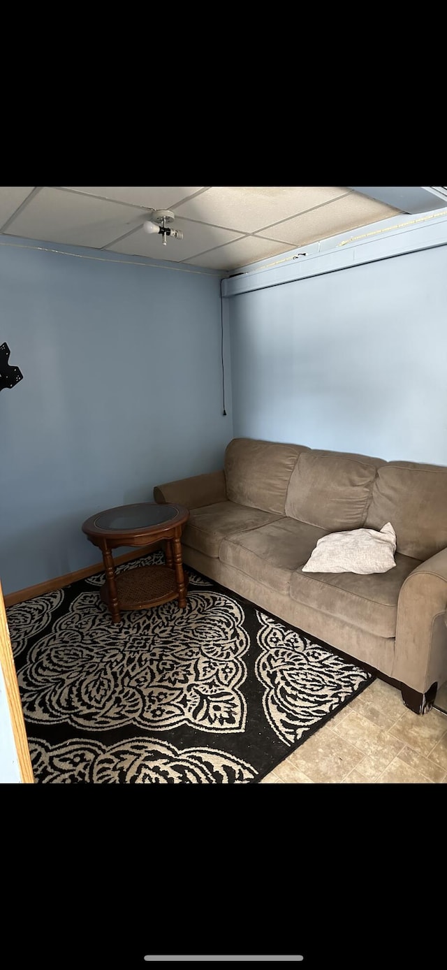 living room with carpet floors and a drop ceiling