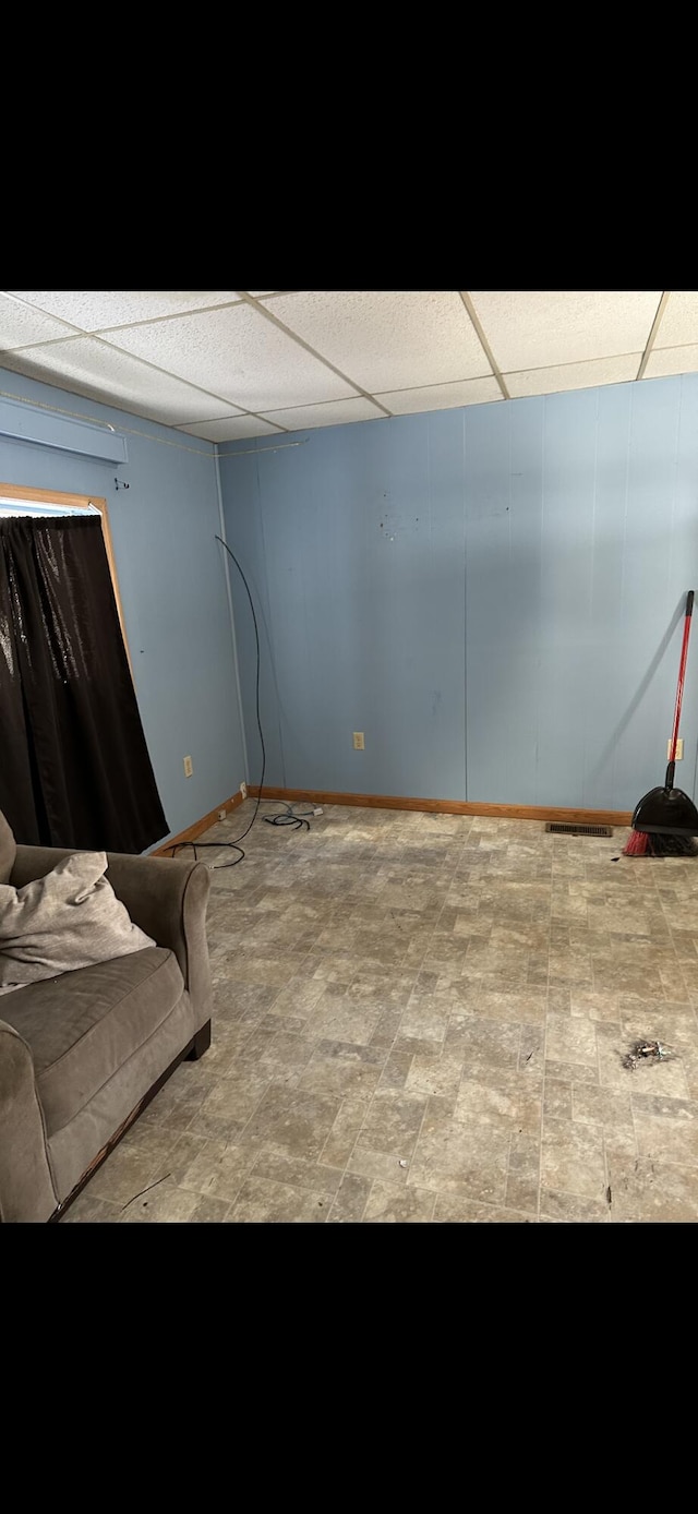 bedroom featuring a paneled ceiling and tile floors