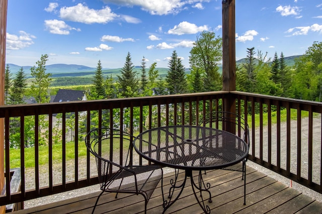 wooden deck with a mountain view