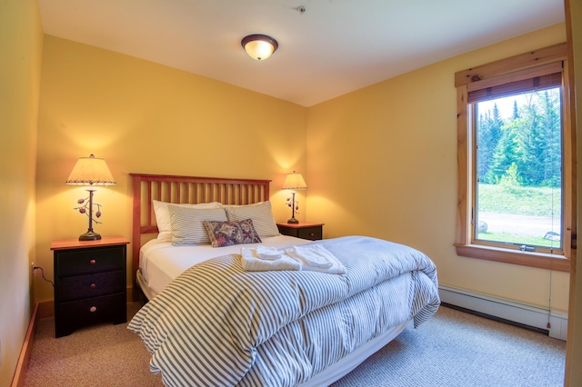 carpeted bedroom featuring a baseboard radiator and baseboards