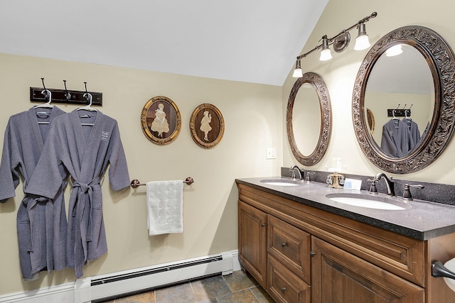 bathroom featuring a baseboard radiator, lofted ceiling, and vanity