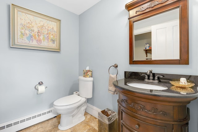 bathroom with toilet, vanity, a baseboard radiator, and tile patterned floors