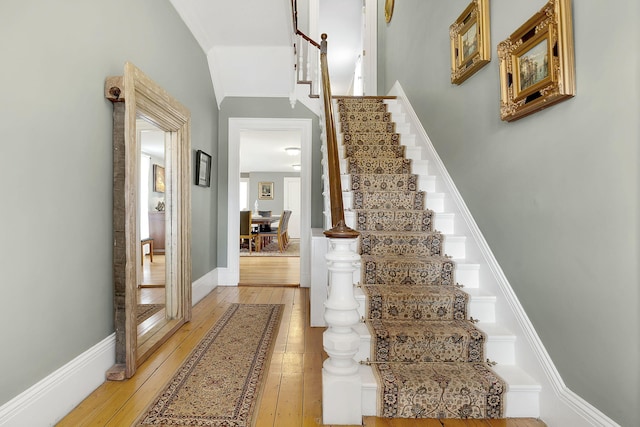 staircase with hardwood / wood-style flooring