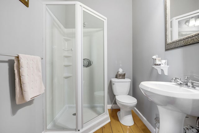 bathroom featuring sink, toilet, walk in shower, and wood-type flooring