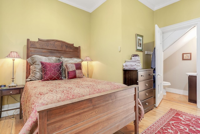 bedroom featuring crown molding and light hardwood / wood-style floors