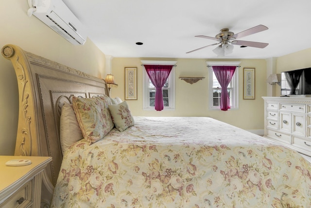 bedroom featuring an AC wall unit and ceiling fan