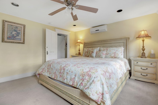 bedroom with a wall mounted air conditioner, ceiling fan, and light colored carpet