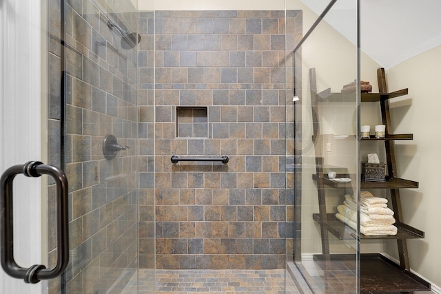 bathroom with vaulted ceiling and an enclosed shower