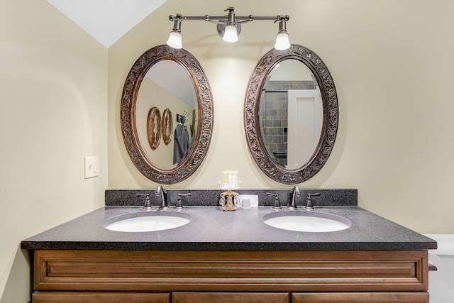 bathroom with vanity and lofted ceiling