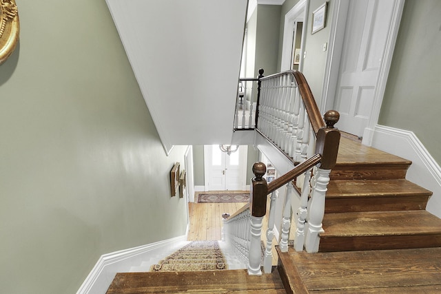 staircase with hardwood / wood-style flooring