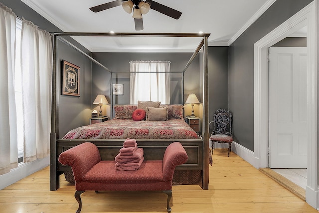 bedroom featuring light hardwood / wood-style floors, ceiling fan, and ornamental molding