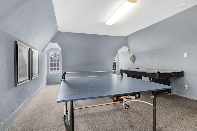 recreation room featuring vaulted ceiling and light carpet