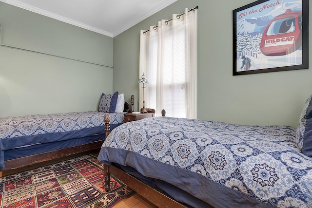 bedroom with hardwood / wood-style floors and crown molding