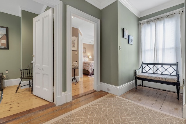 hall featuring ornamental molding and hardwood / wood-style flooring