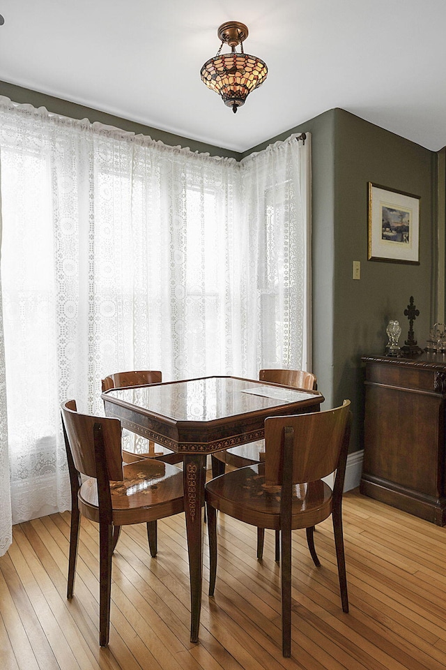 dining space with light hardwood / wood-style floors