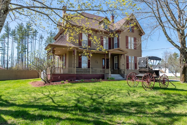 view of front of home featuring covered porch and a front yard