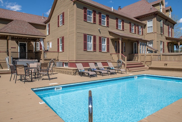 view of pool featuring a patio and a deck