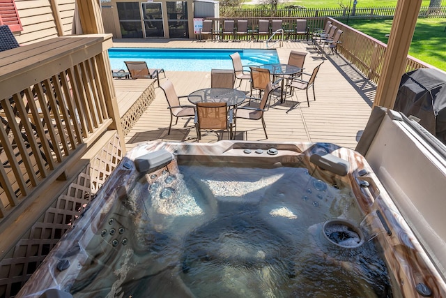 view of swimming pool featuring an outdoor hot tub