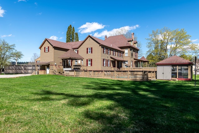 back of property featuring a lawn and a gazebo