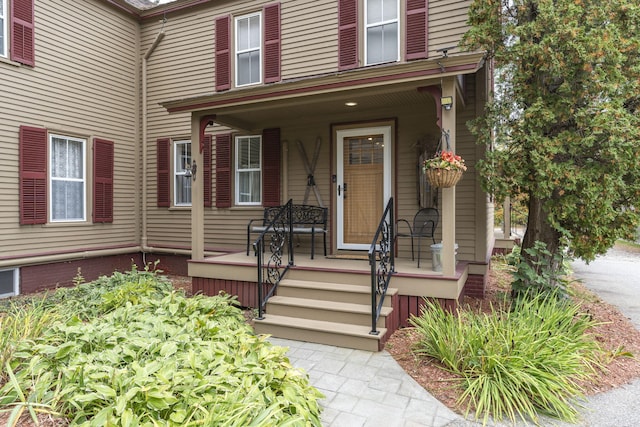 view of exterior entry with a porch