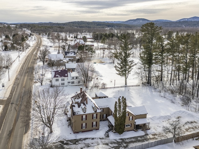 snowy aerial view featuring a mountain view