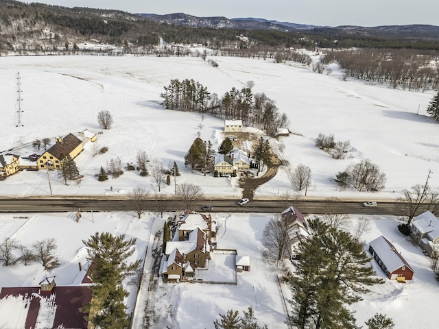 snowy aerial view with a mountain view