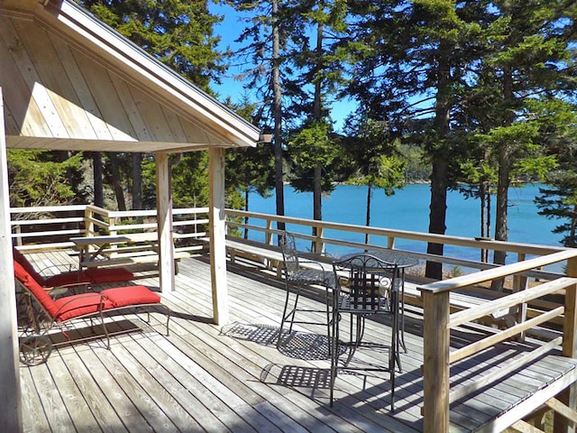 wooden deck featuring a water view