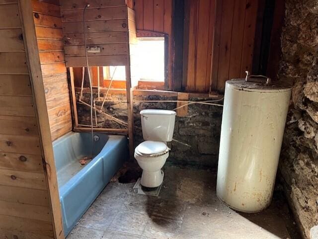 bathroom with toilet, tub / shower combination, and wooden walls