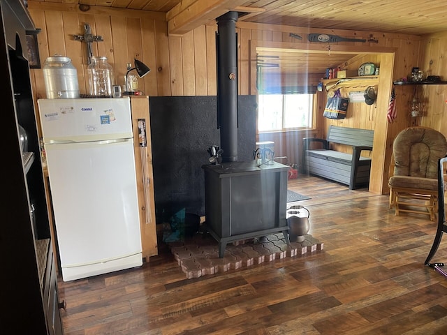 161 Burnt Lndg Unit T16 R5, Wels, ME 04779 - kitchen featuring wooden ceiling, wood walls, white fridge, dark hardwood / wood-style floors, and a wood stove