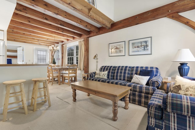 living room featuring beam ceiling and a chandelier