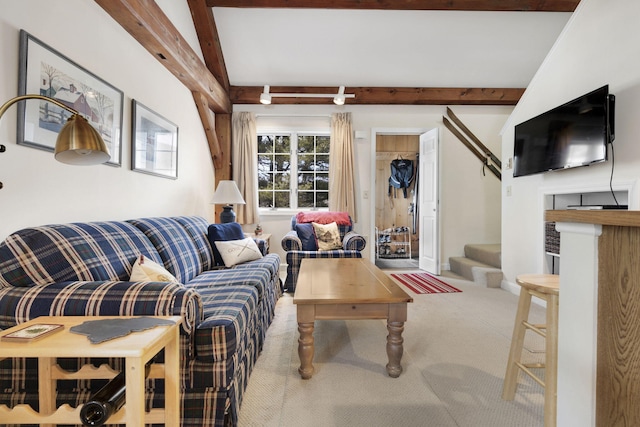 carpeted living room featuring beam ceiling