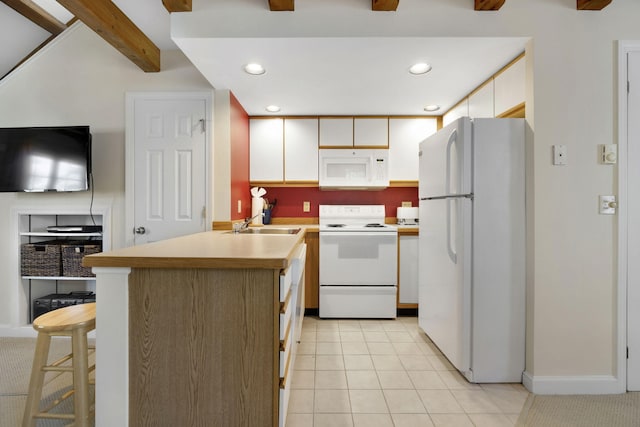 kitchen with light tile flooring, ceiling fan, white appliances, a breakfast bar area, and sink